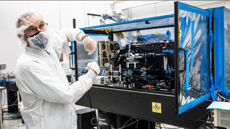 A NASA scientist in front of some equipment