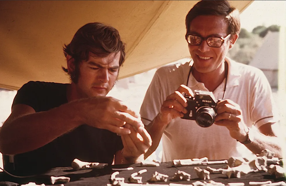 Two people looking at bones of 'Lucy'