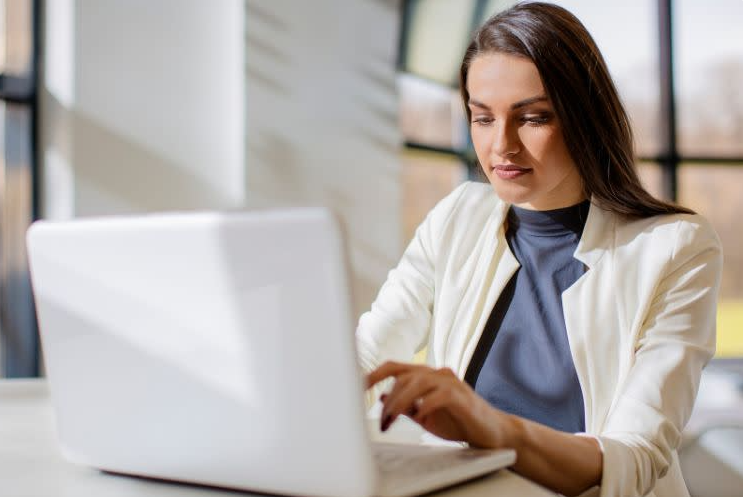 Woman looks at computer