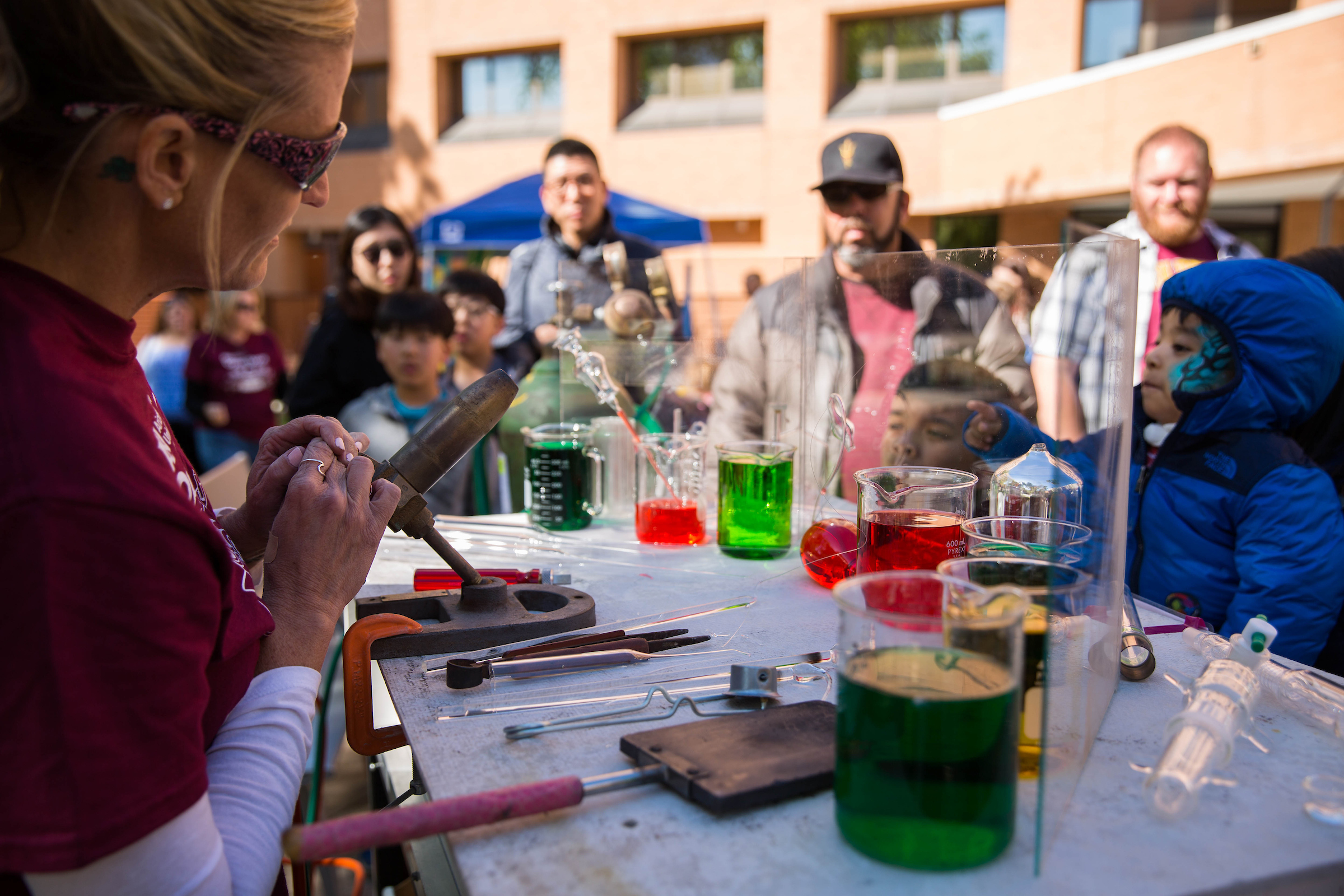 Glassblowing facility manager Christine Roeger demonstrates how glass can be molded with heat and cooling at the Tempe campus on Feb. 24, 2018, for ASU Open Door. Photo by Summer Sorg/ASU Now