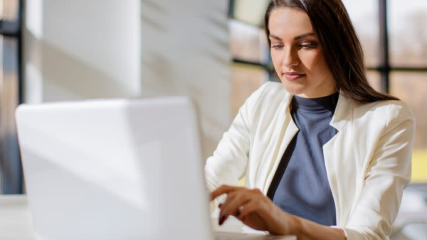 Woman looks at computer