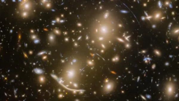 Abell 370 features several arcs of light, including the "Dragon Arc".  (Image credit: NASA)