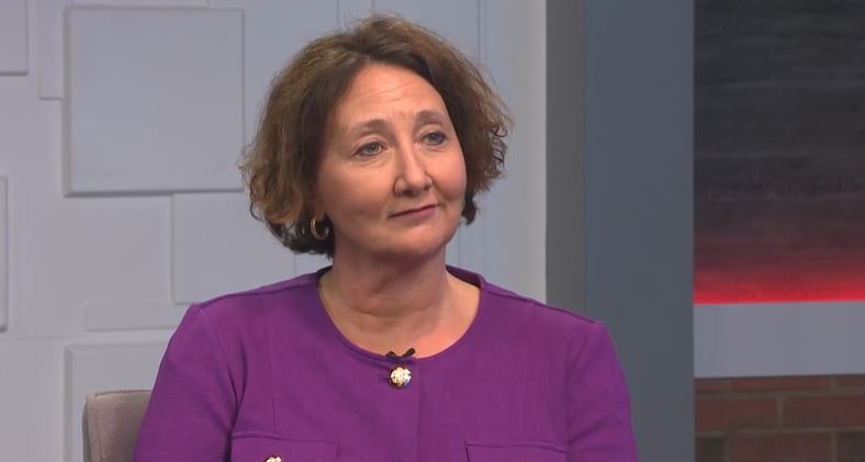 A woman sitting in a television studio