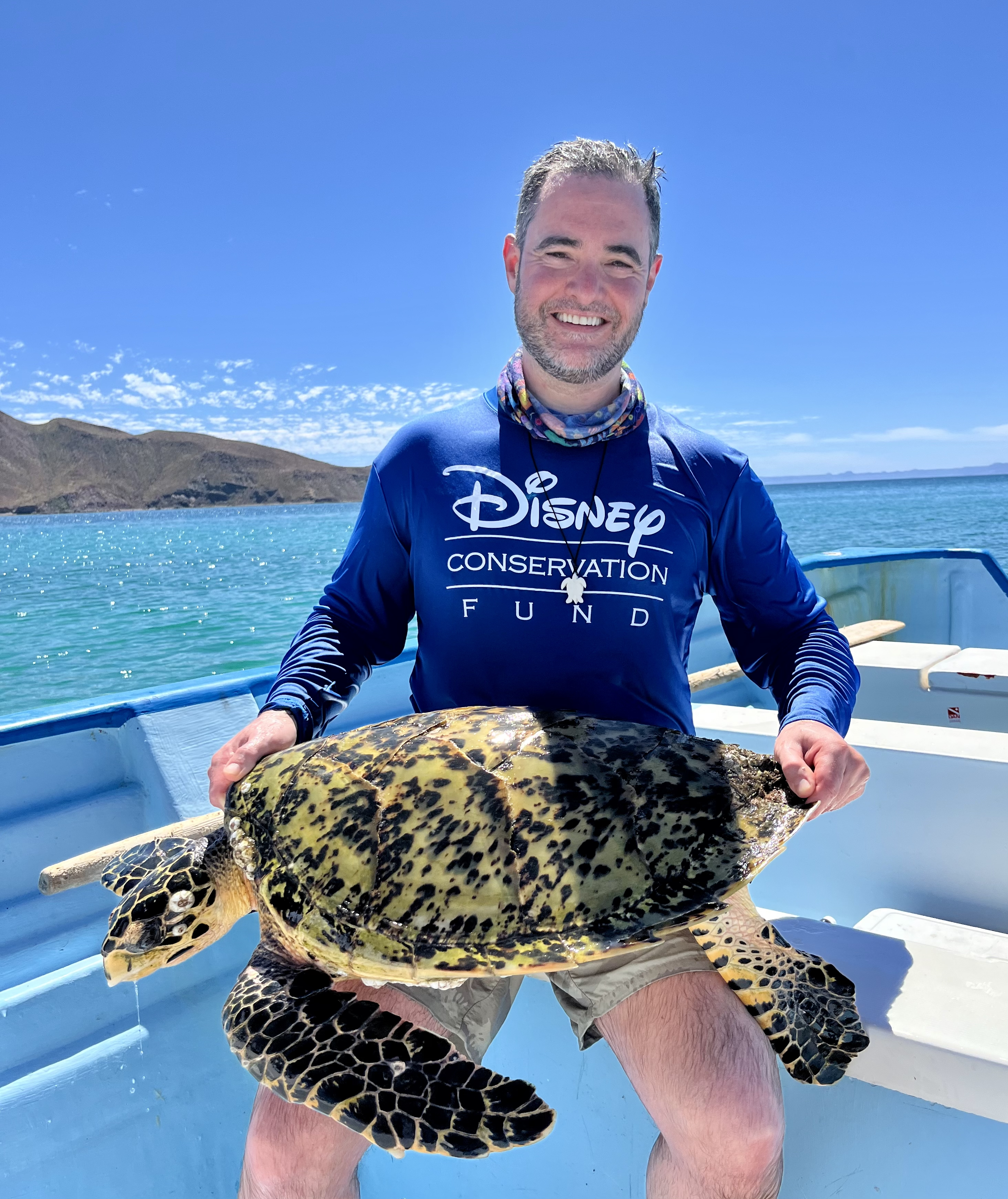 Jesse Senko with a Hawksbill Sea Turtle.